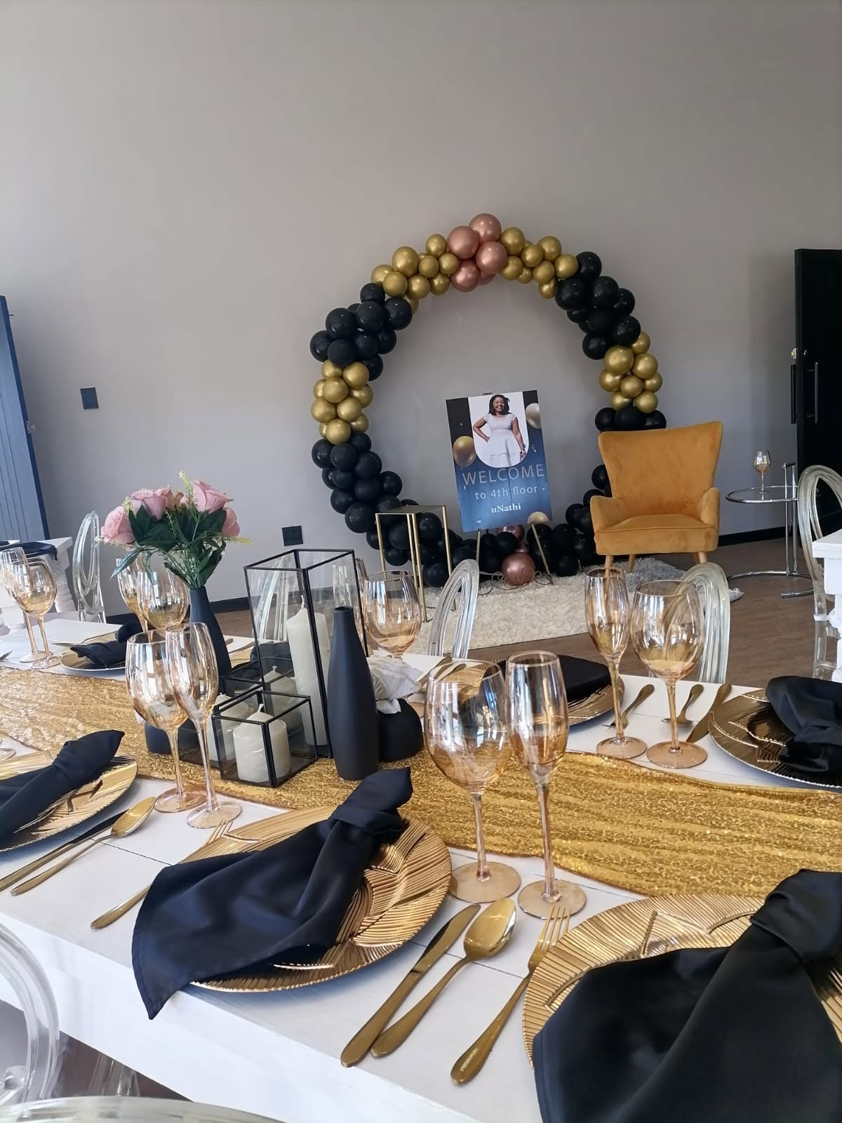 Elegant black, gold and blush event setup with balloon arch at 51 On Kologha