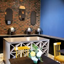 Breakfast nook with brick feature wall and mustard chairs